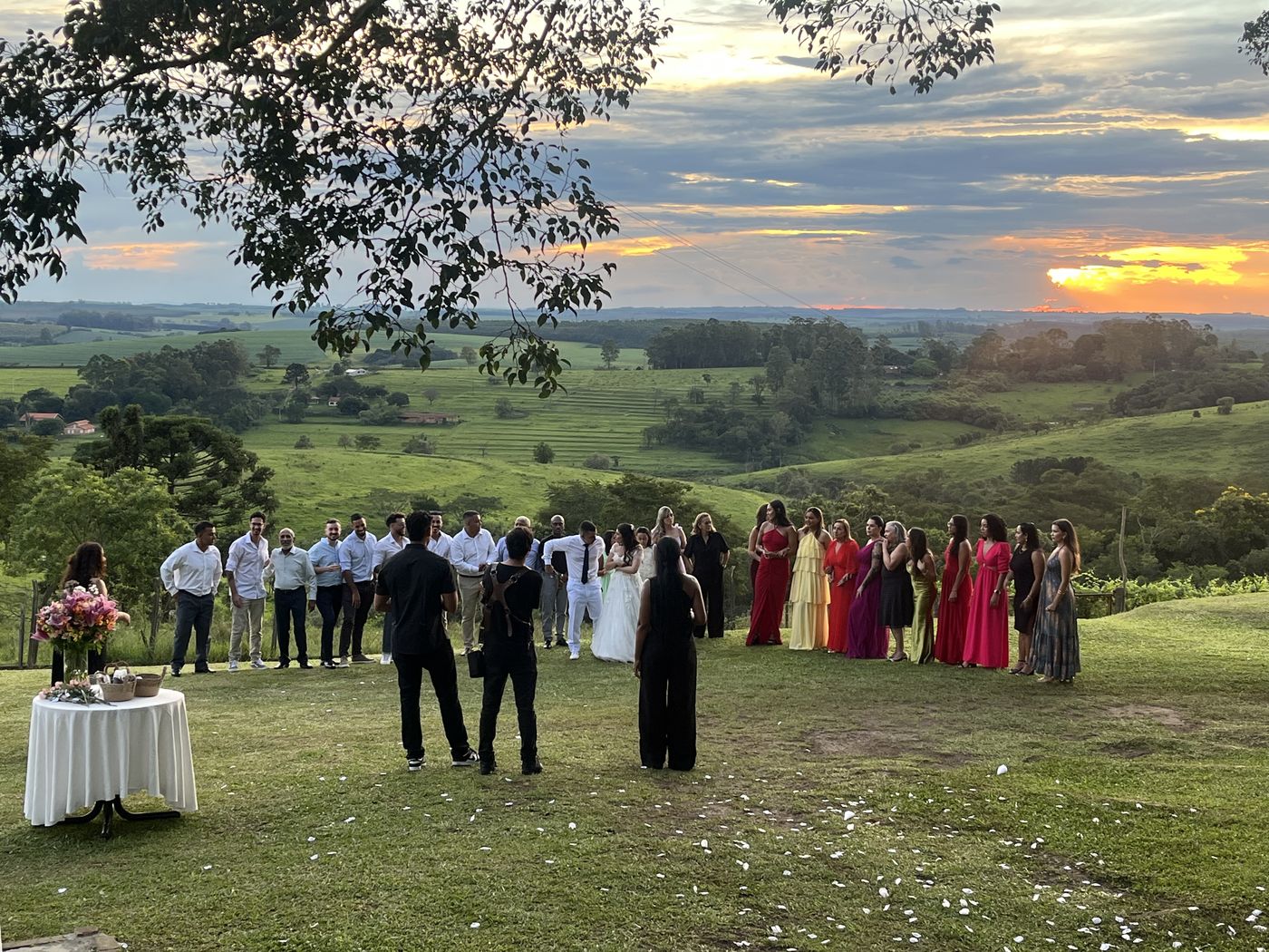 Cerimônia de casamento ao pôr do sol no gramado do Recanto das Seriemas, convidados em semicírculo com vista para o vale — Serra do Itaqueri